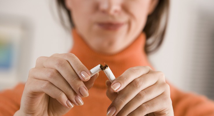 image of woman breaking a cigarette