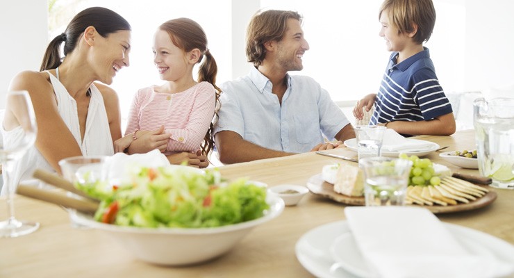 family at dinner table with healthy food
