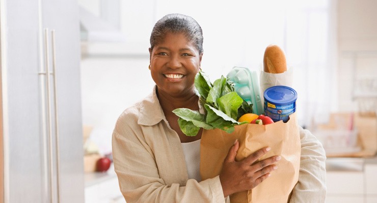 image of woman with bag of groceries