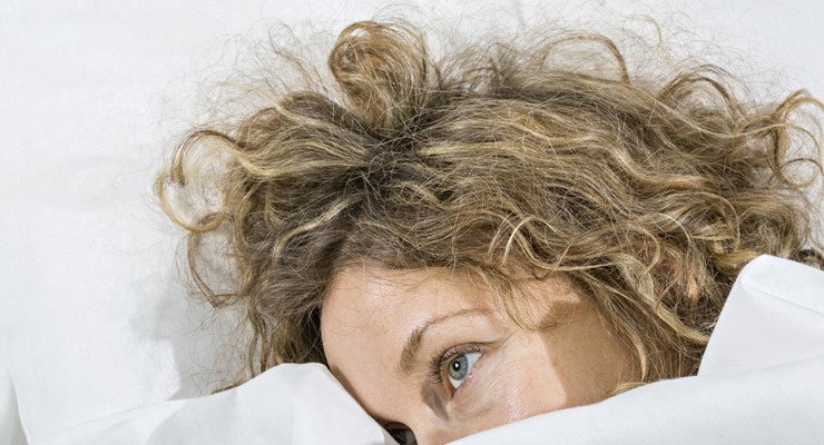 woman under covers with just her head sticking out